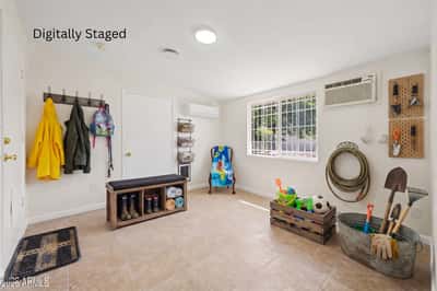 Digitally staged visualization transforms the bonus room into an organized mudroom with practical storage, seating, and everyday organization. This concept showcases another functional use for this flexible Phoenix home.