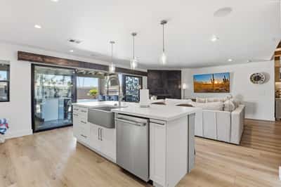 Farmhouse sink, oversized island, and open-concept layout connect the kitchen with the spacious great room and backyard, creating a welcoming environment for entertaining and family gatherings.