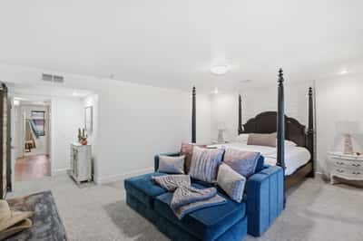 Spacious primary bedroom features comfortable sitting space, elegant finishes, generous proportions, and convenient access to the luxurious ensuite and walk-in closet.
