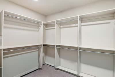 Well-designed walk-in closet provides extensive shelving, hanging space, and organization, complementing the spacious primary suite with practical everyday storage.