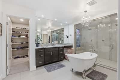Convenient access from the luxurious primary bath leads to a spacious walk-in closet with abundant storage, enhancing everyday comfort and organization.