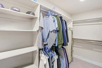 Large walk-in closet provides built-in shelving, hanging areas, and organized storage solutions, complementing the beautifully designed primary suite.