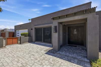 Private front courtyard welcomes guests with attractive pavers, gated entry, and clean modern architecture, enhancing both curb appeal and outdoor living.