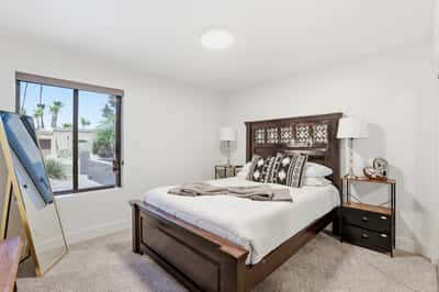 Bright secondary bedroom offers generous natural light, comfortable proportions, plush carpeting, and updated finishes, providing flexible space for guests or family living in Scottsdale.