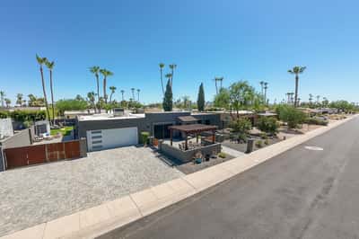 Contemporary front exterior features an oversized paver driveway, RV gate, updated garage door, and clean modern design, offering outstanding curb appeal in Scottsdale.