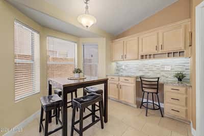 This versatile breakfast area combines casual dining with built-in cabinetry and countertop workspace. Large windows create a bright and welcoming setting for everyday living in Goodyear.