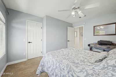 Comfortable and inviting, this secondary bedroom features soft carpeting, ceiling fan, neutral finishes, and excellent natural light. A flexible room that easily accommodates guests or everyday living.