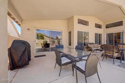 Designed for comfortable outdoor living, the covered patio includes dining and lounge areas with easy access from the home's main living spaces, creating the perfect place to gather with family and friends.