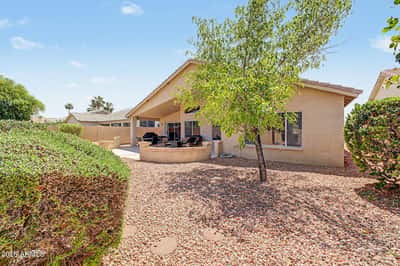 The beautifully maintained backyard offers mature trees, low-maintenance landscaping, and plenty of open space for relaxing or entertaining while enjoying the Arizona sunshine.