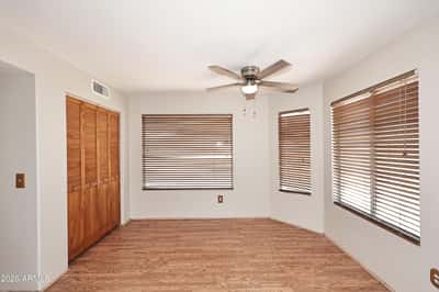 Sunny breakfast nook features multiple windows, abundant natural light, and comfortable space for casual dining while overlooking the backyard.