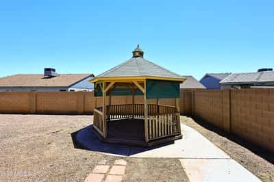Attractive gazebo creates a welcoming outdoor retreat within the spacious backyard, offering a relaxing setting for entertaining or enjoying the Arizona sunshine.