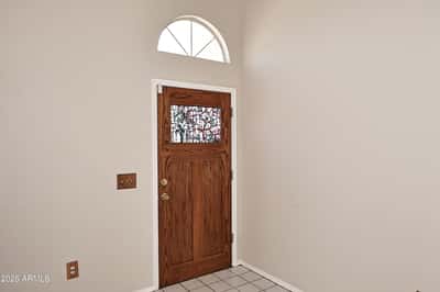 Bright foyer welcomes guests with vaulted ceilings, natural light, and a spacious layout that creates an open and inviting first impression.