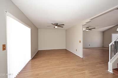 Bright family room offers soaring ceilings, updated flooring, generous living space, and a flexible layout designed for comfortable everyday living.