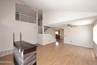 Expansive living and dining area boasts soaring ceilings, updated flooring, and an open layout designed for entertaining, relaxing, and flexible furniture arrangements.