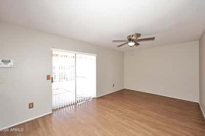 Spacious family room offers updated flooring, ceiling fan, and sliding door access to the backyard, creating an ideal indoor-outdoor living experience.