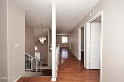 Spacious upper-level landing provides easy access to the bedrooms and loft while enhancing the home's open and airy two-story design.