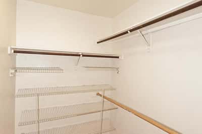 Walk-in closet provides extensive shelving, hanging rods, and ample storage space to help keep clothing and personal items neatly organized.