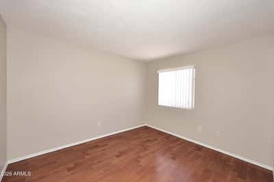 Third bedroom offers updated flooring, natural light, and versatile space that works equally well as a bedroom, office, or creative workspace.