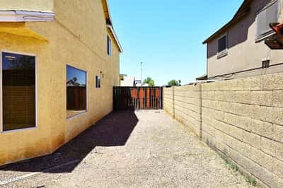 Gated side yard provides convenient RV parking or extra storage space, offering added functionality and flexibility for renters seeking room for larger vehicles in Phoenix.