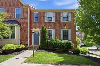 This spacious end-unit townhome features attractive brickwork, abundant natural light, and well-maintained landscaping.