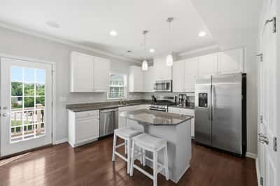 Modern kitchen featuring stainless steel appliances, ample counter space, and bright natural light throughout.