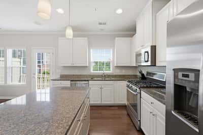 Bright and spacious kitchen featuring modern appliances, ample storage, and a large island perfect for meals.