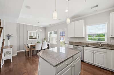Bright, open kitchen features modern appliances, ample counter space, and a cozy dining area for gatherings.