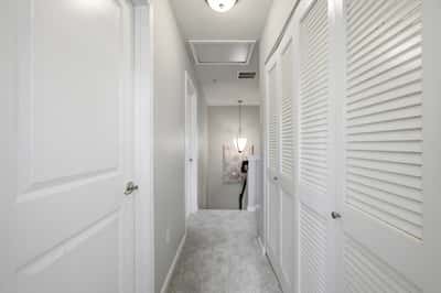 Bright and inviting hallway with ample storage, leading to well-lit living spaces and a cozy atmosphere.