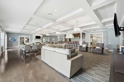 Spacious community gathering area featuring modern decor, abundant seating, and a welcoming atmosphere for social events.