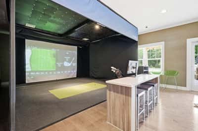 Experience the clubhouse's state-of-the-art golf simulator room, perfect for practice and entertainment.