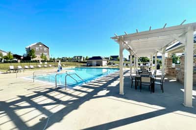 Enjoy a refreshing poolside retreat with ample seating and convenient amenities for relaxation and fun.