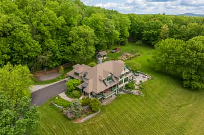 Nestled among lush greenery, this spacious home offers a tranquil retreat with expansive outdoor space and scenic views.