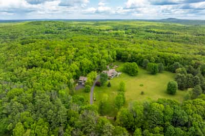 Explore this expansive property surrounded by lush greenery, offering privacy and a unique retreat experience.