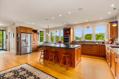 Spacious kitchen featuring ample counter space, modern appliances, and abundant natural light, perfect for gatherings.
