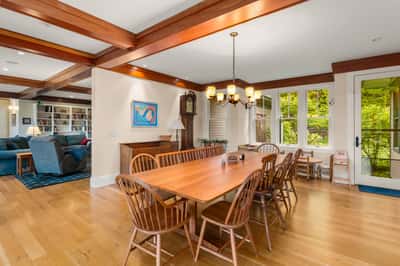 Spacious dining area with natural light, featuring a large table and open flow to the living room.