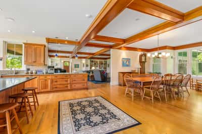 Spacious open-concept kitchen and dining area features warm wood accents and ample natural light throughout.
