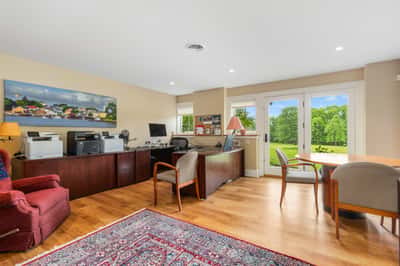 Bright and functional office space with ample natural light and picturesque views of the lush landscape.