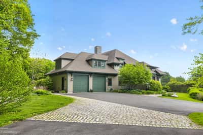 Experience spacious living in this beautifully designed home, featuring a picturesque landscape and inviting driveway.