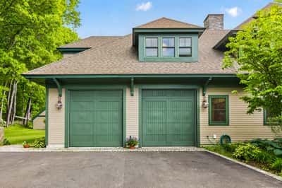 Discover this beautifully designed home featuring a spacious two-car garage and lush surrounding landscaping.
