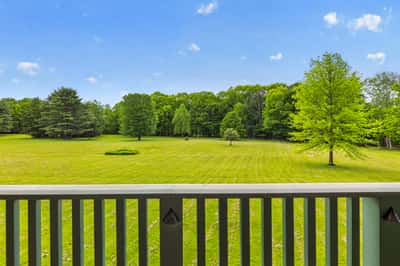 Spacious property featuring expansive green lawns and mature trees, perfect for outdoor activities and relaxation.