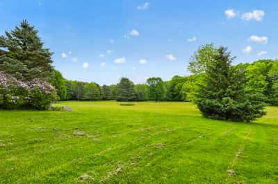 Expansive, lush green landscape offers endless possibilities for outdoor activities and potential development.