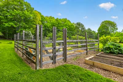 Discover a well-maintained garden area, perfect for cultivating fresh vegetables and enjoying outdoor activities.