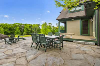 Spacious outdoor patio with ample seating offers scenic views, perfect for entertaining and relaxation.