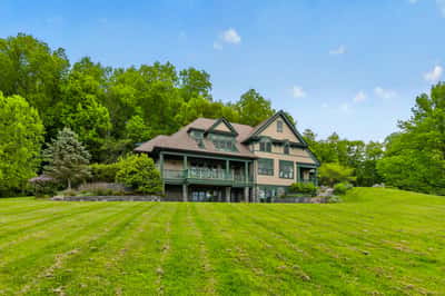 Discover this spacious home nestled on a generous lot, surrounded by lush greenery and natural beauty.