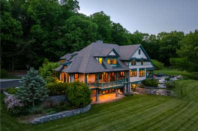 Expansive home nestled in nature, featuring generous outdoor spaces and stunning architectural details throughout.