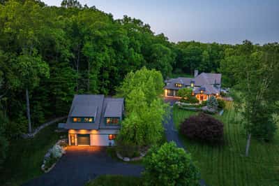 Custom Contemporary home with over 8,000 square feet of finished space on a sprawling ~34 acre lot with detached 4 car garage