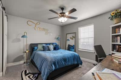 Spacious bedroom featuring natural light from large windows.