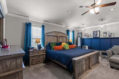 Spacious primary suite featuring high ceilings and modern lighting for a welcoming atmosphere.