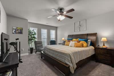 This large bedroom features ample natural light, a spacious layout, and modern amenities for comfort.