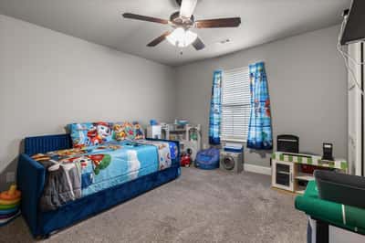 Bright and spacious bedroom featuring ample storage perfect for relaxation and play.